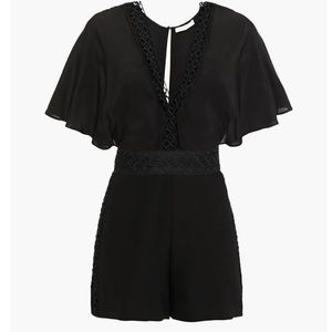 Maje black silk crepe shorts jumpsuit with deep back slit and lace details. Lbd